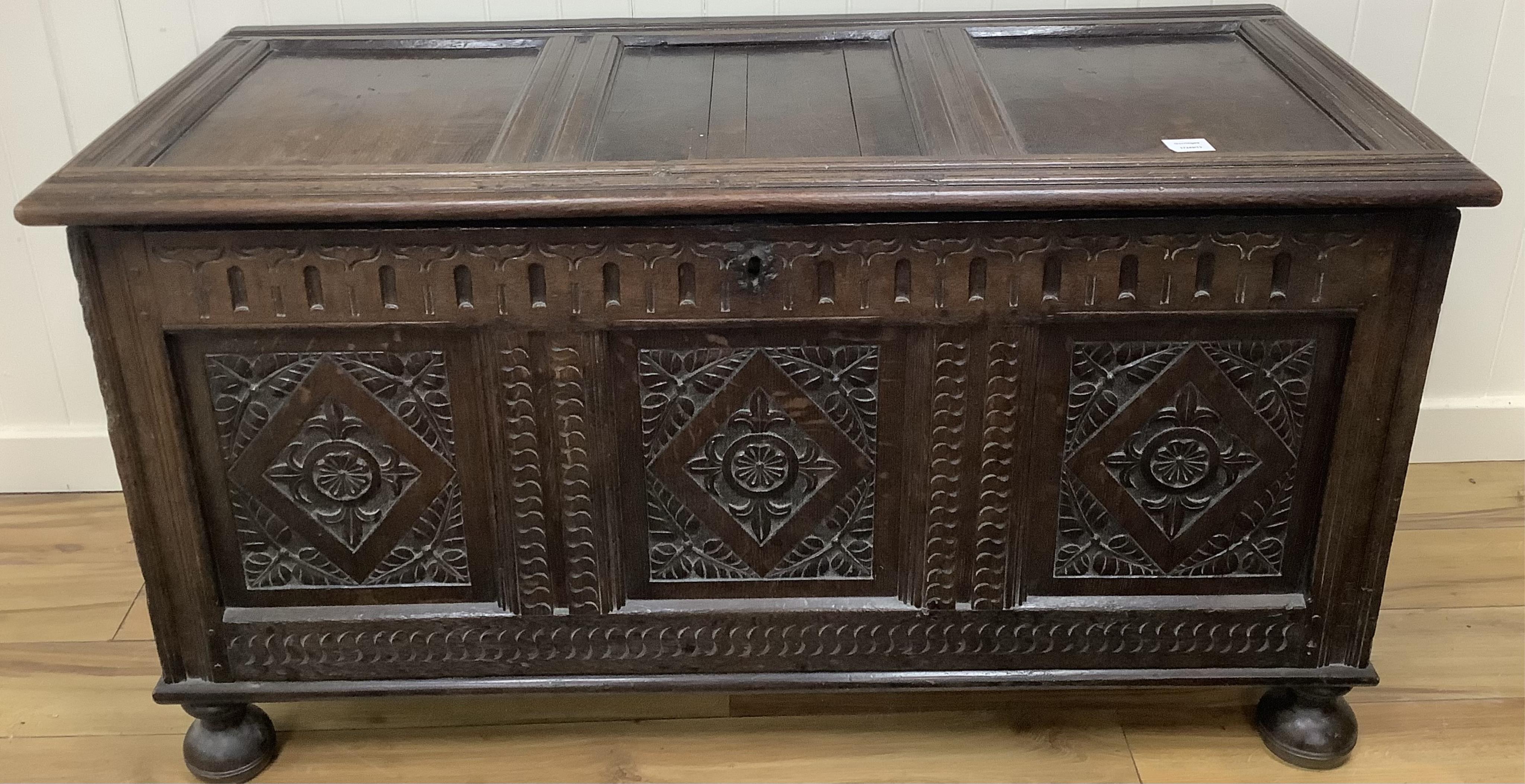 A 17th century and later carved oak coffer, width 128cm, depth 58cm, height 68cm. Condition -fair